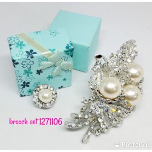 Elegant cream pearls brooch set with clear crystals.