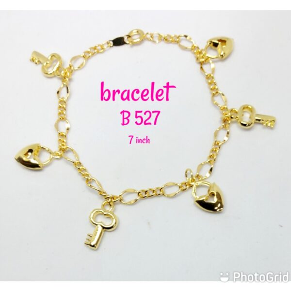 Gold plated shining bracelet with dangling keys and hearts.