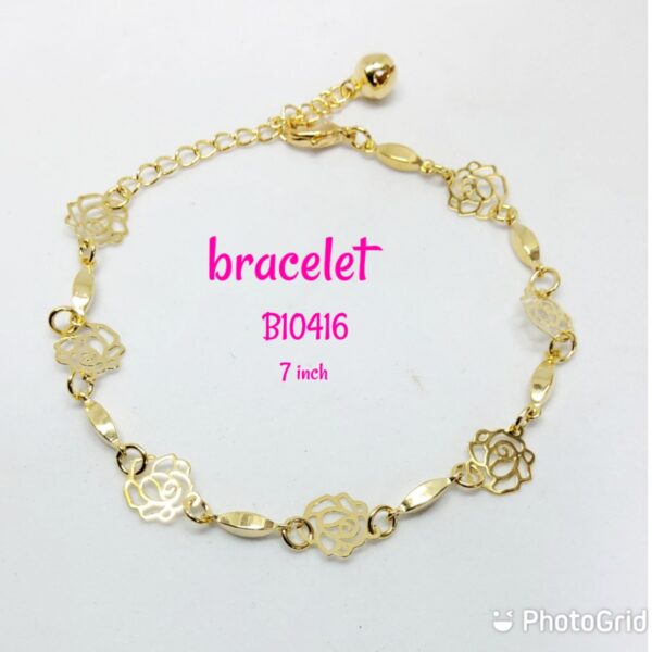 Gold plated rose pattern bracelet with dangling bell.